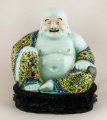A Chinese Figure of a Laughing Buddha In Famille Rose Decoration. Early 20th Century on Wooden Base.