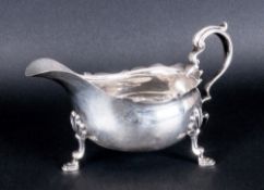 A Silver Sauce Boat with scroll handle, wave borders & raised on four hoof feet. Hallmark