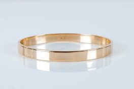 A Soild 9ct Gold Bangle of Plain Form. Fully Hallmarked. Diameter 2.75 Inches. Weight 35 grams. In