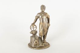 A 1930's/1940's Truck Mascot depicting a blacksmith holding a wheel on an anvil. 4.5 inches high.