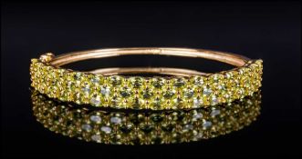 Peridot Three Row Bangle, 11.75cts of bright, sparkling, oval cut peridot, set in three horizontal