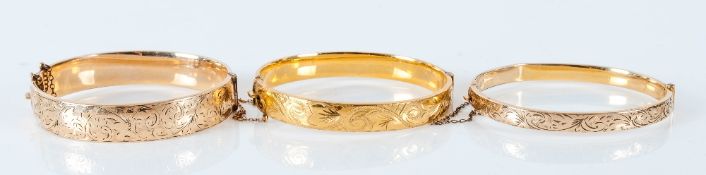 Three Various Rolled Gold Bangles with engraved designs; each an opening, hinged style