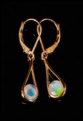 Pair of Opal Pendant Earrings, each earring holding a round cut, faceted opal in a semi-bezel