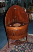 A Mahogany Inlaid Sheraton Period Corner Wash Stand with a bow front and a fitted top with three