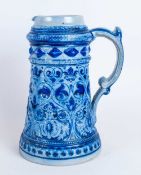 German Stoneware Water Jug, Blue Salt Glaze Moulded Decoration Of Tapering Form. Height 9¼ Inches