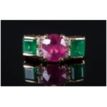 A Fine 18ct Gold Set Ruby & Emerald Ring with diamond spacers. The central faceted ruby of excellent
