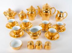 Gilt Porcelain Teaset comprising teacups, sugar bowl, cream jug, condiments, teapot, coffee pot etc.