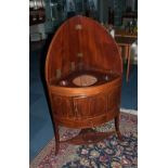 A Mahogany Inlaid Sheraton Period Corner Wash Stand with a bow front and a fitted top with three