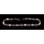 Opal Trellis Pattern Bracelet, nine oval cut, faceted opals, with good displays of colour,