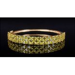 Peridot Three Row Bangle, 11.75cts of bright, sparkling, oval cut peridot, set in three horizontal