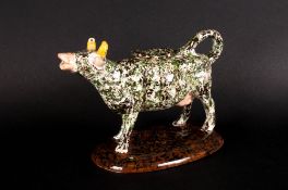 Staffordshire Pottery Cow Creamer with lid, green and black speckled body. 6.5 inches high. Early