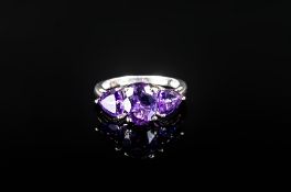 Amethyst Three Stone Ring, a central oval cut of 1.5cts of the deep purple amethyst, flanked by