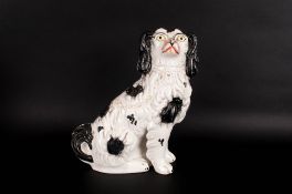 Staffordshire Pottery Spaniel Figure 10.25 inches high. 19thC. With white and gold leaf decoration,