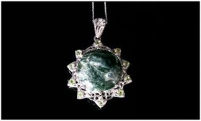 Siberian Seraphinite and Peridot Pendant, a large, round cut seraphinite of 11.75cts, with a good