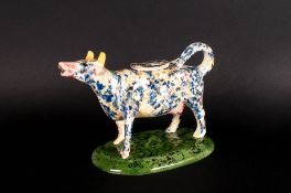 Staffordshire Pottery Cow Creamer with lid, yellow and blue speckled body. 6.5 inches high. Early