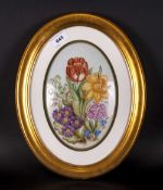 An Oval Porcelain Painted Plaque Of Daffodils & Tulips signed by Julie Merry in a gilt oval frame.