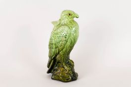 Ault Pottery Eagle Spill Vase with glass eyes and green ground. 11 inches high.