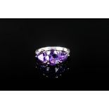 Amethyst Three Stone Ring, a central oval cut of 1.5cts of the deep purple amethyst, flanked by