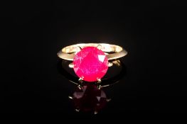 Ruby Solitaire Ring, 5.5cts of round cut ruby in a 9ct gold, six prong setting, allowing the