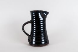 Michael Cardew Monogram Tenmoku Glazed Jug, crack to body 7.5'' in height