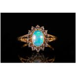 Opal and White Topaz Ring, an oval cut cabochon opal of over 1ct, with a good display of colours,