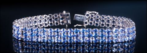 AA Tanzanite Three Row Bracelet, 27.5cts of oval cut tanzanites, closely set in three rows in