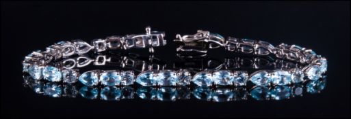 Sky Blue Topaz Line Bracelet, displaying round, pear and oval cuts of the topaz which resembles