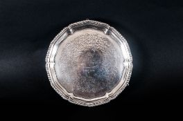 A Fine Victorian Silver Footed Salver with shaped gadroon border. Raised on 3 stepped hoofed feet.