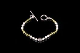Peridot and White Fresh Water Pearl Bracelet, a delicate single row bracelet with the faceted