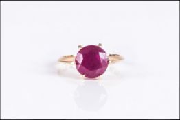 Ruby Solitaire Ring, 5.5cts of round cut ruby in a 9ct gold, six prong setting, allowing the