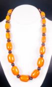 Butterscotch Reconstituted Amber Necklace, graduated ovoid beads interspaced with white metal ethnic