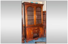 An Edwardian Mahogany Glazed Book Case on Dog Kennel Base. With 2 Shaped Glazed Doors Above, with