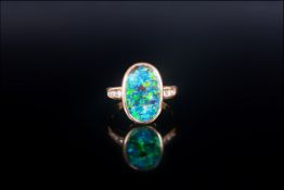 Ladies 18ct Yellow Gold Set Black Opal & DIamond Ring, The oval shaped black opal of good