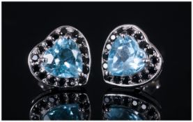 Sky Blue Topaz and Black Spinel Heart Shaped Earrings, each stud earring comprising a heart cut