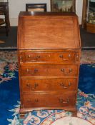 A 18th Century Walnut Bureau. The Fall Enclosing an Interior with Drawers, Cupboard and Pigeonholes,