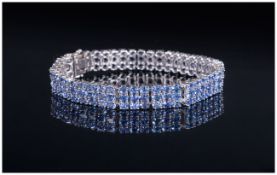 AA Tanzanite Three Row Bracelet, 27.5cts of oval cut tanzanites, closely set in three rows in