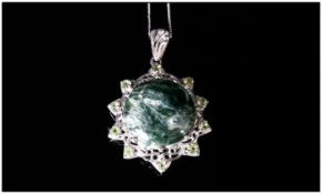 Siberian Seraphinite and Peridot Pendant, a large, round cut seraphinite of 11.