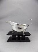 George V Shaped Silver Gravy Boat, Raised on 3 Hoofed Feet with Scroll Handle.