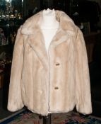 Ladies Faux Fur Short Jacket with slit pockets and rever collar.