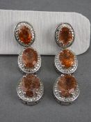 Tanzanian Sunstone Triple Drop Earrings, each earring having three graduated oval cut sunstones,