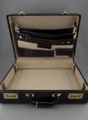 A Modern Black Leather Attache Case with Fitted Stationary Interior and Combination Locks.