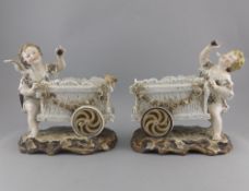 Dresden Late 19th Century Pair of Cherubs Figures with Carts Raised on Naturalistic Bases.