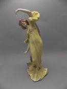 Art Nouveau Hand Painted German Ceramic Figure of a young woman wearing a long flowing yellow dress