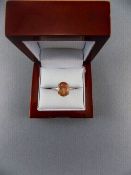 Tanzanian Sunstone Solitaire Ring, a 4ct oval cut of the peach and burnt orange feldspar,