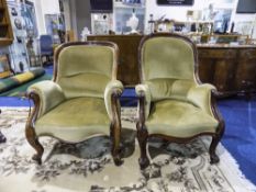 Two Walnut Framed Armchairs of solid construction. Carved front cabriole legs with padded seats.