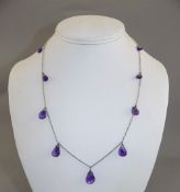 Amethyst Pear Drop Necklace comprising nine graduated, pear cut briolettes of purple amethyst,