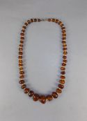 An Early 20thC Natural Amber Bead Necklace 22 inches in length.