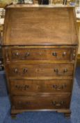 A 18th Century Walnut Bureau. The Fall Enclosing an Interior with Drawers, Cupboard and Pigeonholes,