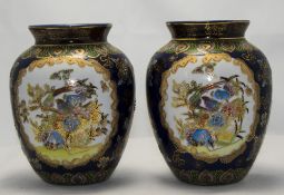 A Pair of Decorative Chinoiserie Vases with embossed floral decoration on a cobalt ground,