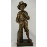 A Goldscheider Figure of a Boy Standing by a Mile Post with one hand in pocket. 23.5 inches tall.